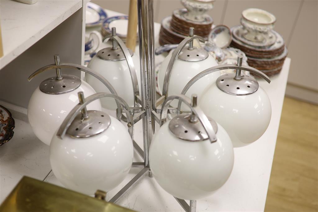 An Art Deco chrome six branch electrolier with white glass shades